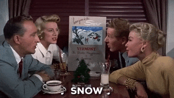 Movie gif. Crowded into a diner booth, Bing Crosby, Danny Kaye, Rosemary Clooney, and Vera Ellen as Bob, Phil, Betty, and Judy in White Christmas sing together while smiling. Text, "snow."