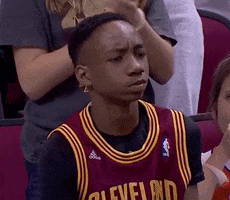 Video gif. A puzzled NBA fan squints his eyes inquisitively and leans his head back as if to say, "huh?"