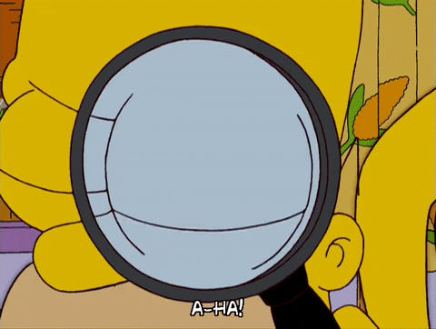 Homer Simpson looking through a magnifying glass
