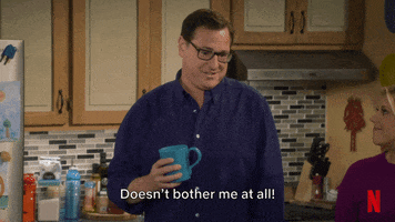 TV gif. Bob Saget as Danny on Fuller House. He jovially says, "Doesn't bother me at all!" while his mug explodes at the strain, revealing his lie.
