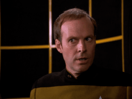 TV gif. Dwight Schultz as Reg on Star Trek looks skeptically and frowns, pointing, as he slowly says, "How... how do you know about that?" which appears as text.