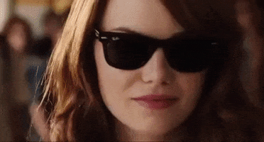 Movie gif. A sunglasses Emma Stone as Olive in Easy A blows a seductive kiss at us.