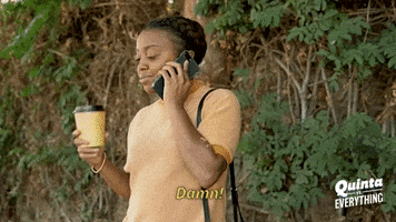 TV gif. Talking on her phone outside, Quinta Brunson in Quinta vs. Everything raises a cup of coffee to her mouth and says, “Damn!”