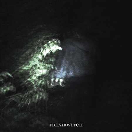 Blair Witch horror GIF by Lionsgate showing a close-up of a figure with glowing eyes in the dark