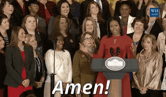 Political gif. Michelle Obama standing at a podium in front of a crowd of women, raises up her hand. Text, "amen!"