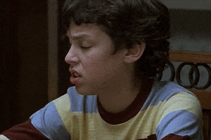 TV gif. John Francis Daley as Sam in Freaks and Geeks. He's sitting at the dining table and he looks up in annoyance as his brows furrow and he gives us a deadpan expression.