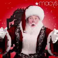 Video gif. A man playing Santa sits on a throne, his arms outstretched towards us, and says,