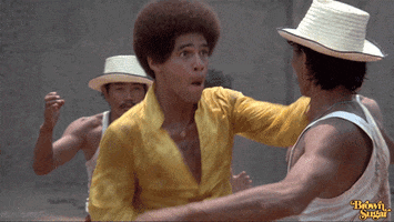 Movie gif. Jim Kelly as Jones in Hot Potato punches a guy straight in the face, and then punches him again while grabbing the back of his neck. He makes sound effects with his mouth as he punches. 