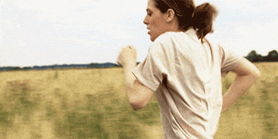 Movie gif. Honor Swinton Byrne as Julie in "The Souvenir" running through a tall grassy field.