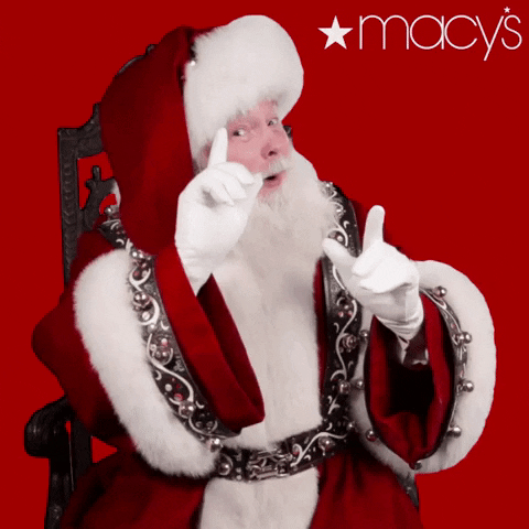 Ad gif. A Macy's ad with Santa Claus leaning forward, looking jolly, and pointing his finger up, which creates a spark. 