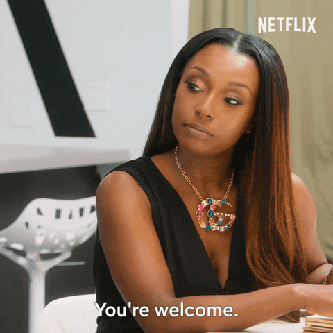 Reality TV gif. Juawana Colbert on Selling Tampa. She looks down and says, "You're welcome," before turning back to her desk to get back to business.