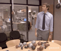 The Office gif. John Krasinski as Jim in a room with half-blown up brown balloons and toilet paper streamers and points and asks, "What is that?" The camera pans to a paper banner that says, "It is your birthday," with a period at the end instead of an exclamation mark.