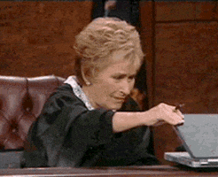 screening tenants with social media: gif is judge judy closing a laptop with a look of disgust on her face