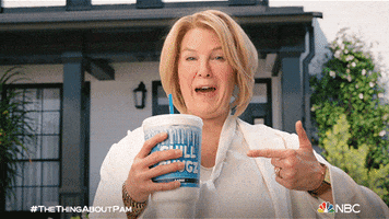 TV gif. Renee Zellweger as Pam on The Thing About Pam looks at us giving a big exaggerated wink. She sips on an extra large fountain soda and  points it. 