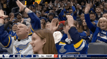 Sports gif. Fans at a St. Louis Blues hockey game are wearing blue and have both arms up in a ninety degree angle and they move them up and down in a fan chant.