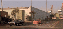 Movie gif. Vin Diesel as Dom and Paul Walker as Brian from Furious 7. They pull up to a stop and look at each other in their respective cars, as they're about to race. 