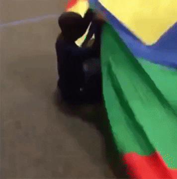 Kid Gets Dragged Under Parachute GIF