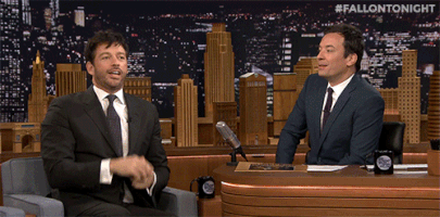 TV gif. Jimmy Fallon and his guest cup their hands up to their mouths and yell, “Boooooooo!”