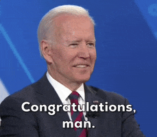 Video gif. Joe Biden gives a cool smile as he mouths the words below, "Congratulations, man."