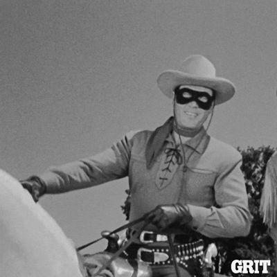 TV gif. Clayton Moore as the Lone Ranger wears a black bandit mask and rides a white horse while waving at us.