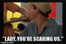 Movie gif. Adam Sandler as Billy and Joyce Gordon as Lunch Lady in Billy Madison. She's holding a tray of sloppy joe's and Billy is sitting in a cafeteria with a bunch of kids. He says, "Lady, you're scaring us" before turning back to cackle with his group.