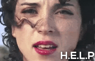 Celebrity gif. Close up on the singer St. Vincent’s face. Her eyes are furrowed in a sad, concerned expression as she stares straight at us. Wind whips her curly hair into her face. And she says, “Help me.” The text in the corner says, “H.E.L.P.”