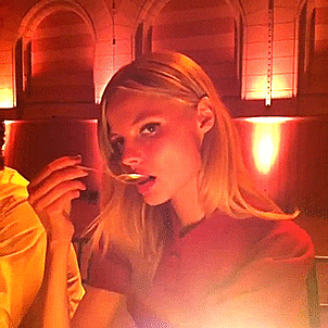 Celebrity gif. Magdalena Frąckowiak, a model, has a spoon to her mouth and she slowly turns to the camera, staring at us sexily.