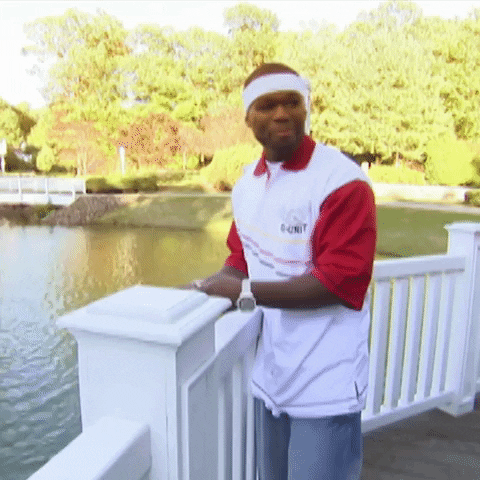 Celebrity gif. From MTV Cribs, 50 Cent on a dock smiles humbly and nods.
