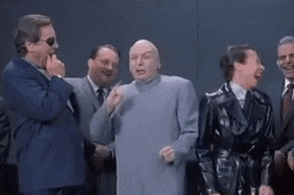 Movie gif. Mike Myers as Doctor Evil in Austin Powers stands with a bunch of other evil people and they all laugh like they’re making fun of or mocking someone else.