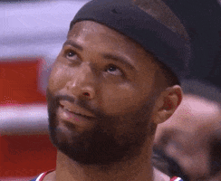 Video gif. A sweaty Demarcus Cousins wears his LA Clippers jersey and a sweatband as his rolls his eyes, then closes them and shakes his head. 