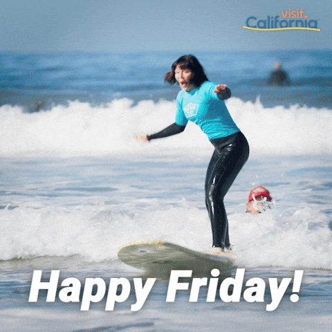Sponsored gif. Woman in a wet suit excitedly throws her hands in the air as she successfully rides a surfboard on the waves of the incoming tide at a beach in California. Text reads, “Happy Friday!”