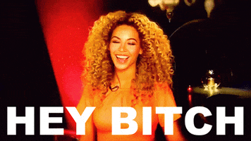 Celebrity gif. Beyonce smiles at us and cocks her head to the side as she says, "Hey bitch," which appears as text.