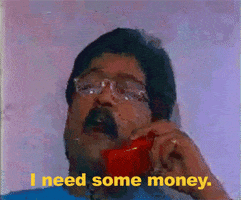 Video gif. Man is on a red landline phone and he says, "I need some money." He takes a beat and peers down at us above his glasses and ends with, "Immediately."