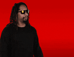Celebrity gif. We zoom in on Lil Jon, who holds up his hands and shouts excitedly into the air. Text, "Yeah!!"