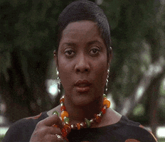 Movie gif. Loretta Devine as Gloria Matthews in Waiting to Exhale absently plays with her necklace, spaced out as she stares at us.