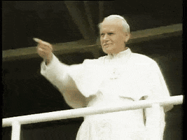Celebrity gif. The Pope stands at a railing and points into the distance before shaking his fist affirmatively.