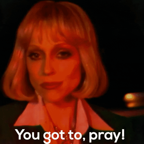 Music video gif. St. Vincent in Pay Your Way In Pain sings and looks at us as the image blurs and fades to her raising her hands in prayer. Text, "You got to, pray!"