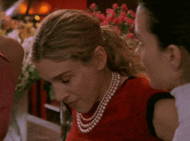 TV gif. Sarah Jessica Parker as Carrie in Sex and the City turns her head toward a woman with a harsh glare.