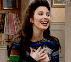 TV gif. Fran Drescher as Fran Fine on The Nanny holds her hands up to her heart with a big smile on her face. She sighs like she’s gushing with excitement. 