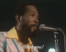 Celebrity gif. Performing onstage in a yellow collared shirt and a light blue jacket, a sweaty Marvin Gaye speaks into a microphone. Text, "Thank you!"