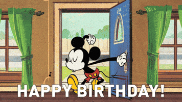 Disney gif. Mickey Mouse opens his front door into his house, whistling with his eyes closed. He opens his eyes and sees a surprise party with all his friends cheering for  him. Balloons float around the ceiling and confetti falls around them. Text, “Happy Birthday!”