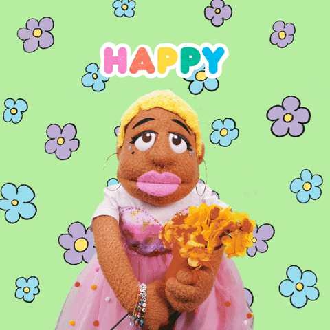 Video gif. Sunnie Dee, a puppet with medium brown fur and short blonde hair, wearing a pink tulle dress and holding a bouquet of yellow flowers against a lime green background with pulsing flowers. She looks at us with a smile, bobbing her head from side to side and says, "Happy birthday!" which appears in rainbow-colored text. 