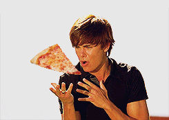 Meme gif. Zac Efron as Troy in High School Musical sings dramatically and gestures, appearing to summon a superimposed pizza slice into his mouth.