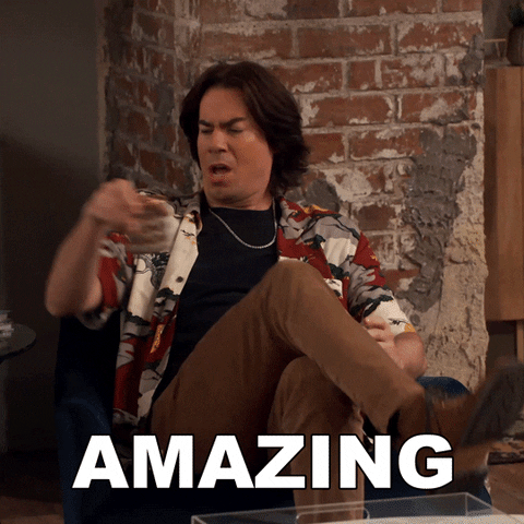 TV gif. Jerry Trainor as Spencer puts his drink down, crosses his legs and leans forward to look at someone off screen, saying emphatically, "Amazing."