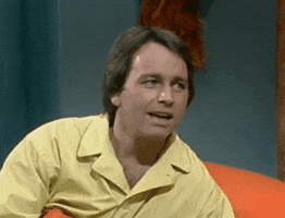 TV gif. John Ritter as Jack in Three's a Crowd, looks over at someone, licks his lips, and tilts his head slightly, raising his eyebrows, as he says, "Well, as a matter of fact, there is something...."