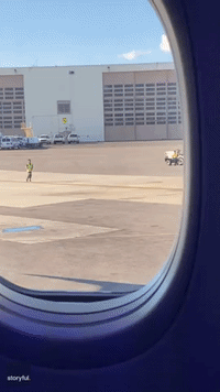 Baggage Handlers Play Catch on Tarmac at Reagan National Airport