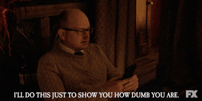 TV gif. Mark Proksch as Colin in What We Do in the Shadows cradles his phone as he texts rapidly with both thumbs and says, "I'll do this just to show how dumb you are."