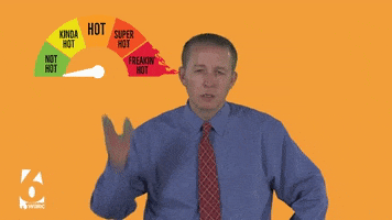 TV gif. Overheated, Meteorologist Wes Wyatt waves a hand in front of his face and shakes his head beneath a meter that quickly moves from “not hot” to “kinda hot” to “hot” to “super hot” to “freakin’ hot.”