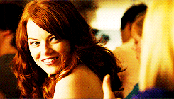 Movie gif. Emma Stone as Olive in Easy A looks over her shoulder and gives an enthusiastic thumbs up. 
