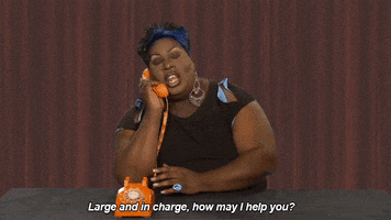 TV gif. Latrice Royale answers a phone on RuPaul's Drag Race and says "Large and in charge, how can I help you?'